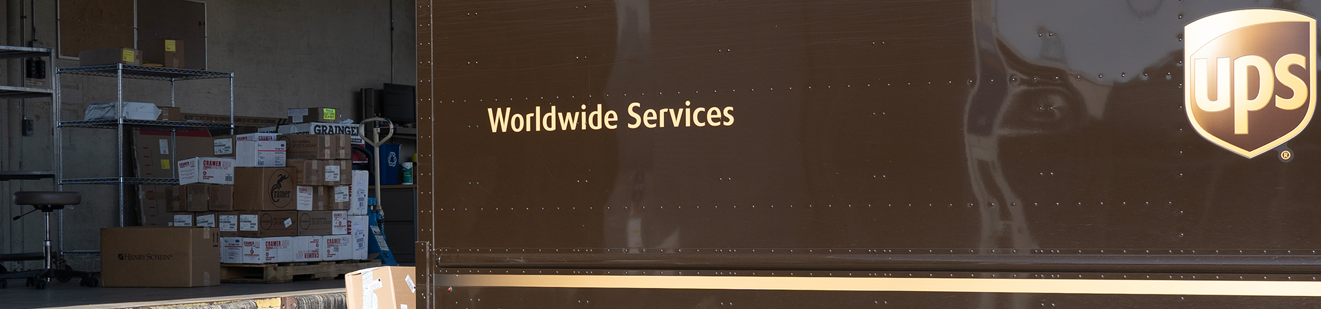 A UPS truck unloads packages at the Receiving Services dock.