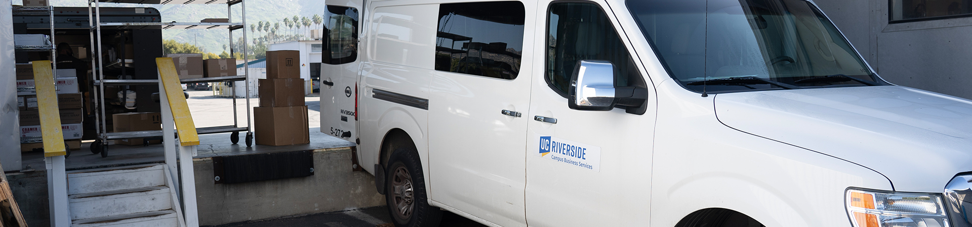 A van unloads packages at the Receiving Services dock.