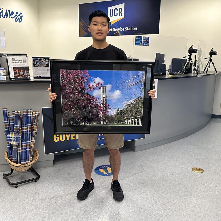 Han Li R'Card Contest Winner with framed winner.